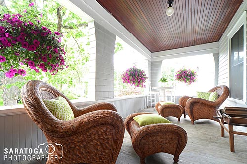 Soft moody filtered summer light wicker chairs on porch